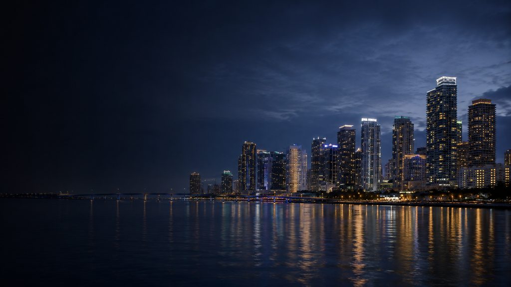 Downtown Miami skyline at dusk along Biscayne Bay &mdash; the South Florida real estate market SHAMA Kapital invests in